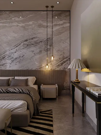 Pendant lights hang like jewelry against the marble backdrop, providing soft, ambient light. A sleek console table and modern art piece complete this corner, balancing richness with clean, contemporary lines.