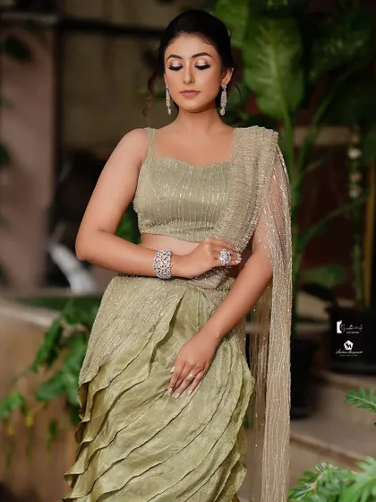 The full look shows a modern, ruffled lehenga, and the makeup is kept soft and glowing to balance it.