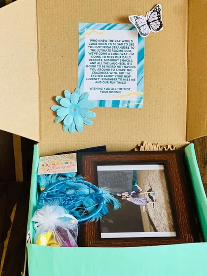 Another view inside the farewell box, showing the custom card with a personal message for the departing roommate.