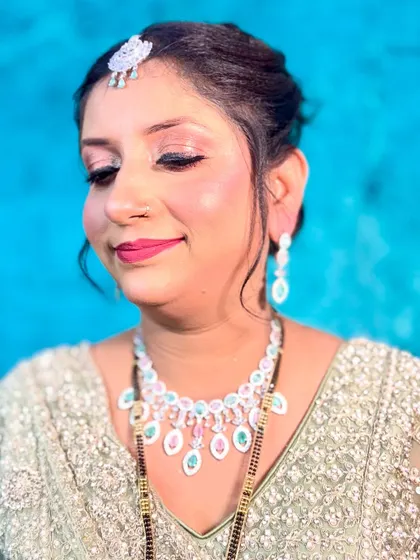 A soft and pretty party look with a mint green outfit. The makeup features pink tones on the eyes and cheeks for a fresh, youthful glow.