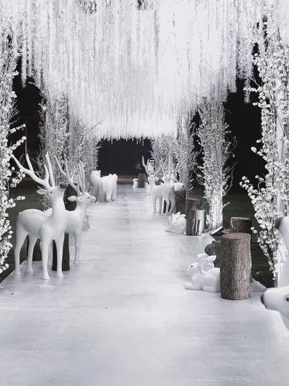 We craft magical celebrations for every milestone. This 'Winter Wonderland' first birthday party featured an enchanting entrance with a forest of white trees and arctic animals, creating a whimsical and immersive experience for the youngest of guests and their families.