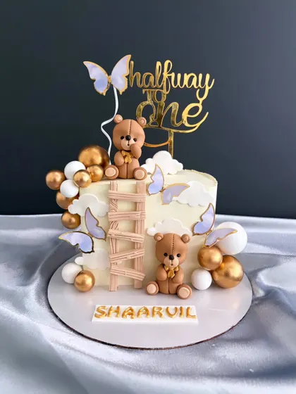 Halfway to one! I had so much fun making this adorable teddy bear cake for Shaarvil's 6-month celebration, complete with a tiny wooden ladder, butterflies, and golden accents.