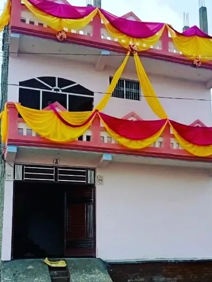 A simple house balcony decoration using pink and yellow drapes in a swag pattern.