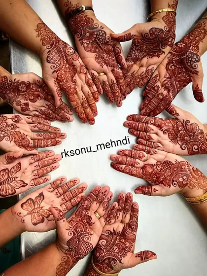 A beautiful shot of a family celebrating together, with each person wearing a unique Arabic-style design. I love creating complementary art for the whole bridal party and family.