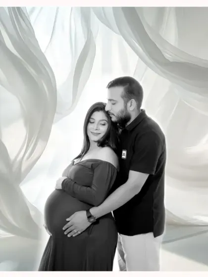 An elegant and artistic studio maternity portrait. For a classic look, I use soft lighting and beautiful backdrops to create timeless images for expecting parents.