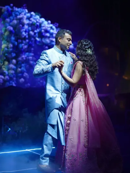 The couple shares a romantic dance, surrounded by the magical blue and purple lighting of their 'Starry Night' themed party.