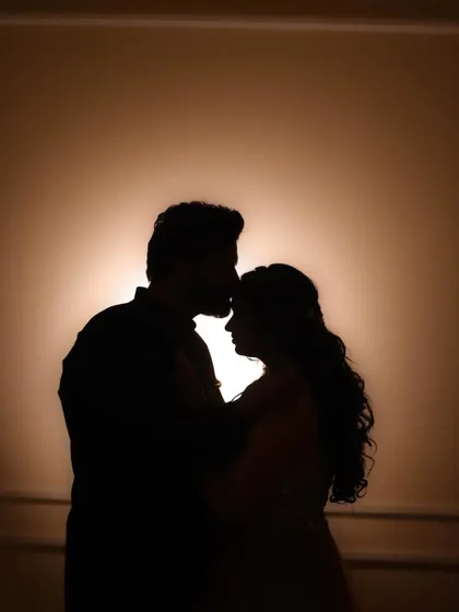 A beautiful silhouette of the couple against a warm light, creating a timeless and romantic engagement portrait.