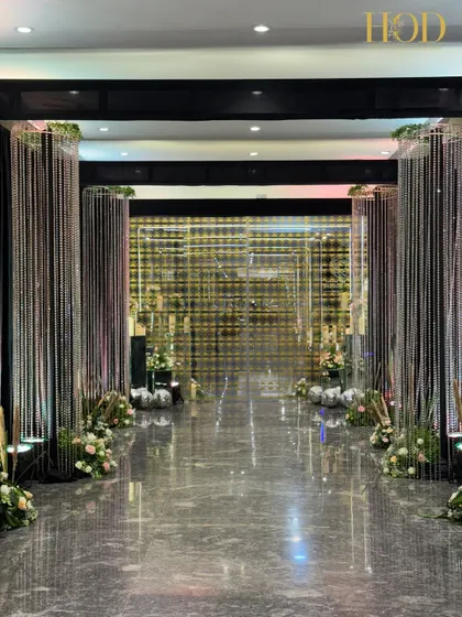 Another angle of the crystal string hallway, showing the beautiful reflections on the marble floor. The clean lines and shimmering textures provide a sophisticated and high-end feel for the event.