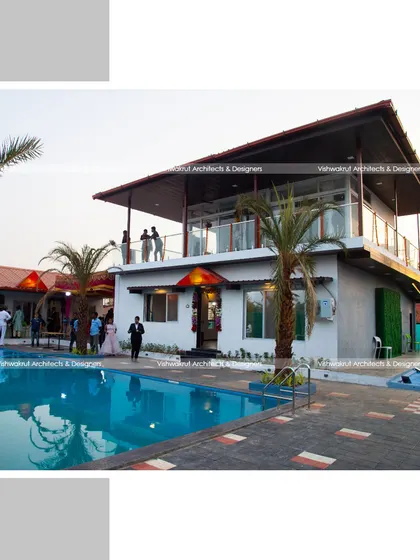 The completed villa during an evening event. This photo shows how the space comes alive, with the upper balcony providing a great vantage point over the pool area.