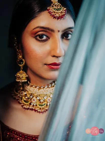 An intense and beautiful close-up portrait of the bride, Khushi, with a play of light and shadow across her face.
