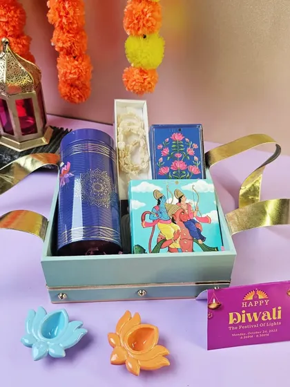 A simple and elegant Diwali gift set in a leather-finish tray. It contains a tea canister and other festive items, perfect for a minimalist yet thoughtful gift.