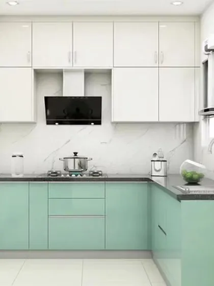 A compact L-shaped kitchen that is perfect for smaller apartments. The mint green and white cabinets, along with a white marble-look backsplash, make the space feel bright and open.