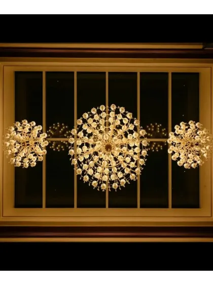 A trio of crystal chandeliers set against a wood-framed ceiling window. This lighting design choice adds a touch of modern glamour while complementing the traditional aesthetic of the home.