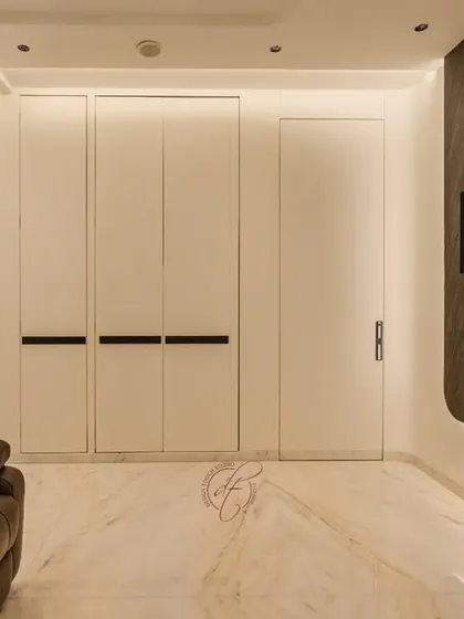 This is the ultimate entertainment zone. The space features a large projection screen on a dark stone accent wall, plush leather recliners, and a hidden mini-bar, creating a true home cinema experience.