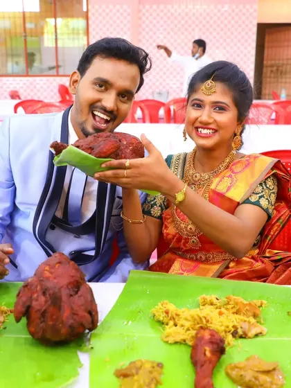 All smiles from this happy couple as they pose with their wedding feast. The vibrant colors of their attire are matched by the rich colors of our food.