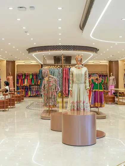 The second floor, dedicated to wedding couture and festive wear, features a modern, pastel palette. The copyrighted Nalli "Chintz" print was adapted as a wallpaper pattern, adding a bespoke touch.
