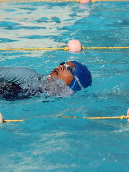 A swimmer practices their backstroke technique, focusing on body rotation and a high elbow catch. We break down each stroke to ensure maximum efficiency and power.