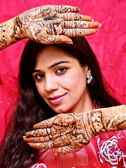 A confident bride showing off her intricate henna. My goal is to make every bride feel beautiful.