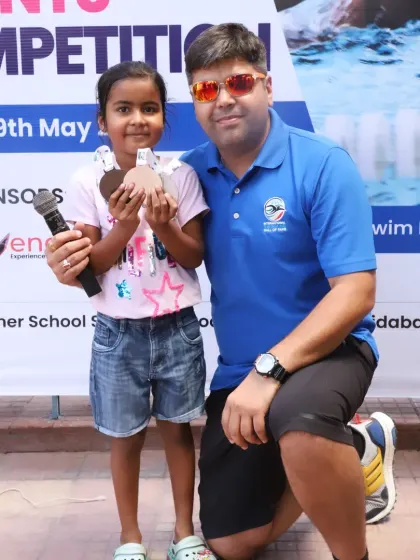A moment with a young participant and her medal. Every swimmer who gives their best is a winner in my eyes.