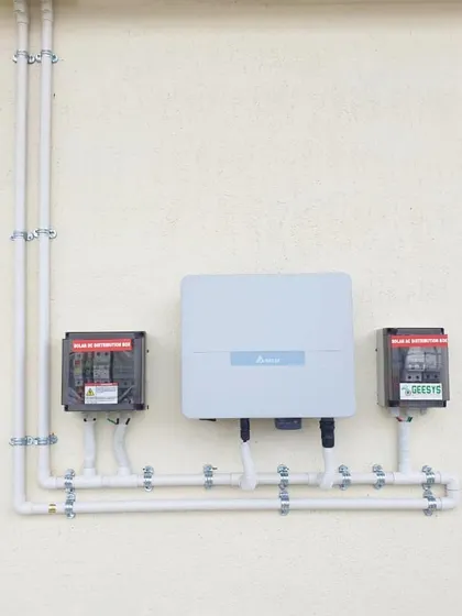 A perfect example of our commitment to neat and clean work. This wall-mounted inverter and distribution box setup features organized wiring, ensuring safety and a professional aesthetic.