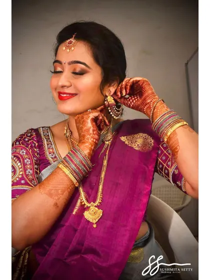 Capturing the final touches, this image shows the bride looking radiant and happy. Her makeup is designed to last, keeping her looking perfect from the first photo to the last.