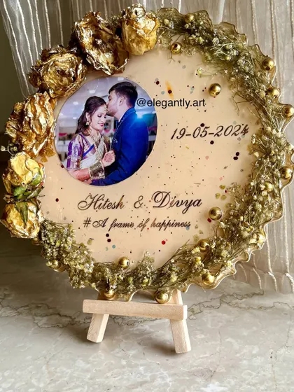 Preserve the magic of your wedding day with this elegant flower photo frame. It showcases wedding flowers around a beautiful photo, with names and a date in golden perfection.