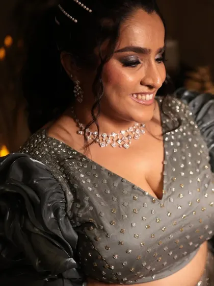 A close-up of a glamorous sangeet look. The makeup features a dramatic smokey eye and glowing skin, perfect for a night of celebration.