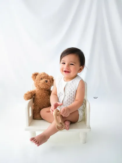 Sitting pretty in his little chair with a teddy bear companion. A simple and sweet baby portrait.