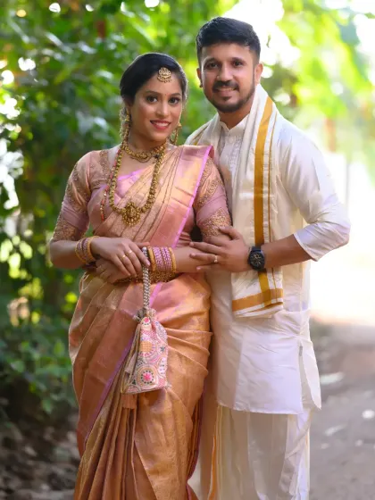 A full-length portrait of the couple in their traditional attire. The soft morning light and the rustic path create a serene and timeless feel for this pre-wedding photo.