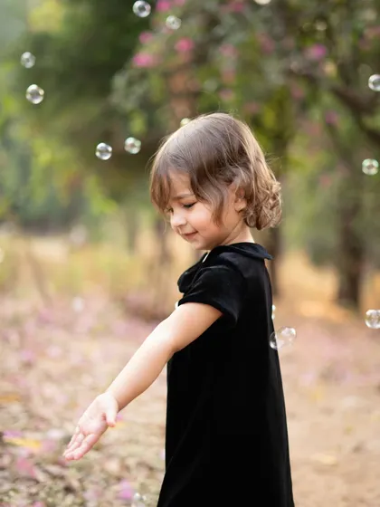 The simple joy of chasing bubbles in a beautiful garden. I use activities like this to bring out natural smiles and capture the carefree spirit of childhood during my outdoor toddler photoshoots.
