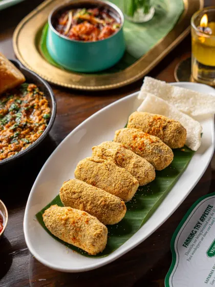 Mutton pattice served on a banana leaf at Gallops. The traditional presentation and golden-brown crust are the focus, highlighting the dish's authentic flavours.