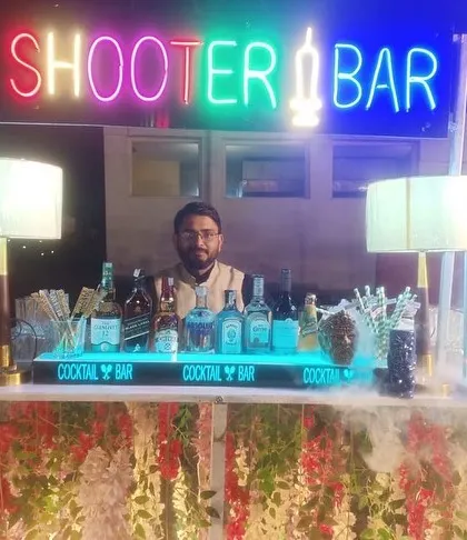 I can customize the bar decor to fit any style. Here, the 'Shooter Bar' is decorated with floral arrangements for an elegant touch.