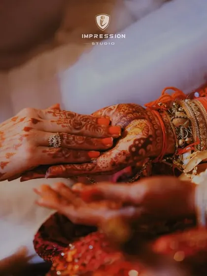 Candid moments, genuine smiles. A close-up on the couple's hands during a wedding ritual, a powerful symbol of their union.