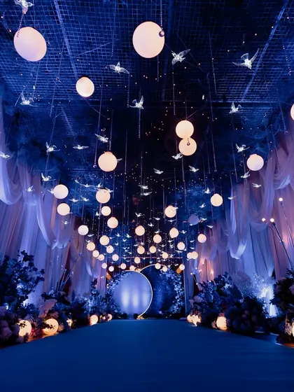 For this Sangeet, we turned the ballroom into a celestial dream. With deep blue lights and a ceiling full of stars, it was a night where love felt written in the cosmos.