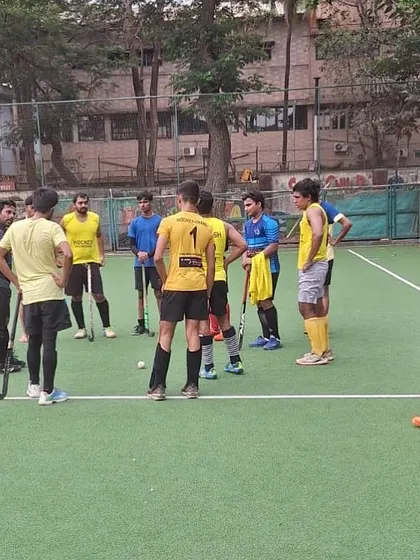 A team huddle during a practice match, where players strategize and motivate each other. This moment highlights the importance of communication and teamwork in our program.