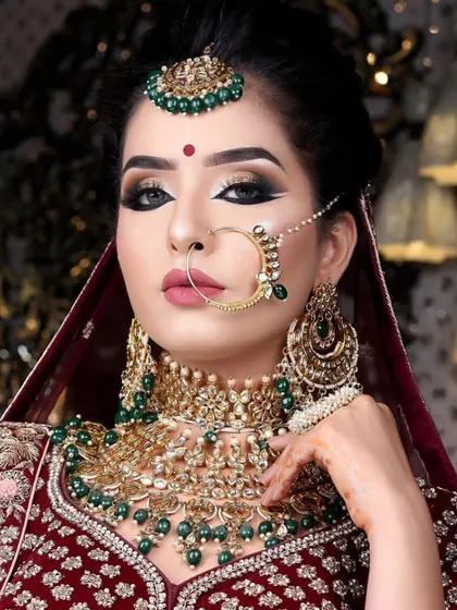 A bold and beautiful look featuring a heavy choker with emerald green beads. The dramatic makeup complements the jewellery perfectly.