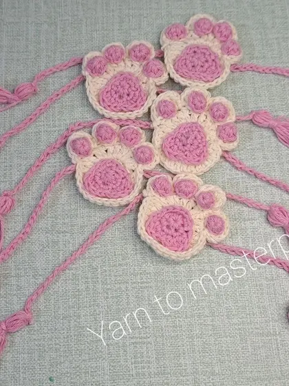 A closer look at the crochet paw print rakhis. I make these with soft cotton yarn so they are comfortable to wear all day.