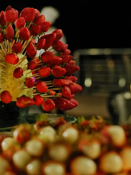 An artistic display of fresh strawberries on skewers. Our fruit displays are designed to be both a healthy dessert option and a beautiful centerpiece.