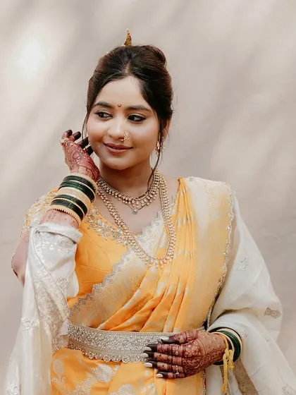 Draped in tradition, adorned with grace. This bride looks absolutely radiant in her yellow Nauvari, captured in the soft sunlight.