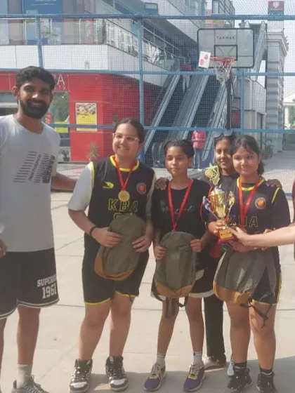 Our Under-14 girls team celebrating their win at the 3x3 Decathlon tournament. They played with skill and determination to earn this trophy.