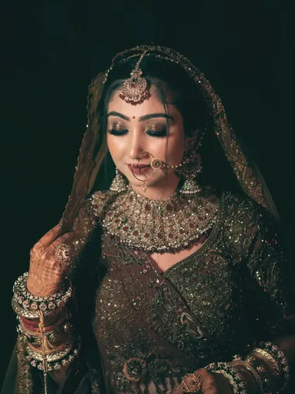 A beautiful portrait of the bride in her wedding finery, looking down gracefully.