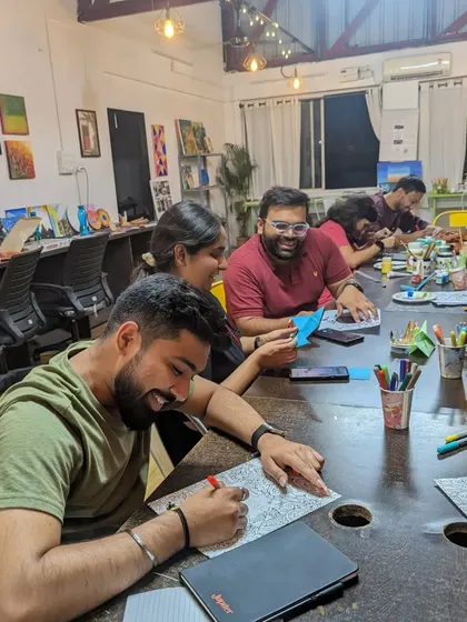 A group of participants enjoying a relaxed evening of coloring and conversation.