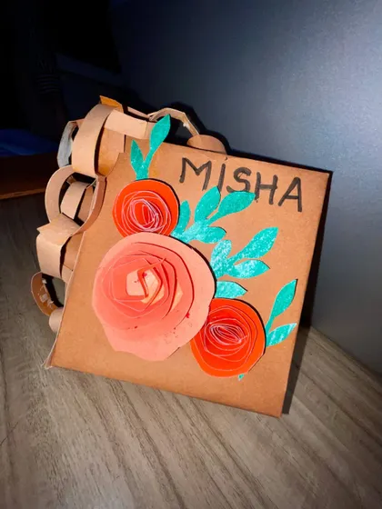 A close-up of the finished paper purse, showing the 3D paper flowers and hand-drawn details. It’s a beautiful example of turning simple AWT material into a showstopper.