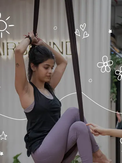 A participant prepares for a move on the aerial silk. This shot captures the focus and determination required for this beautiful art form.