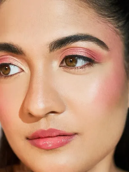 A close-up of the soft pink tones on the eyes and cheeks, which perfectly complement the floral theme.