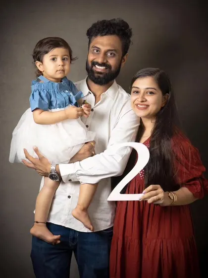 Celebrating a second birthday with a classic family portrait. The number prop adds a fun, personal touch to mark this special milestone.
