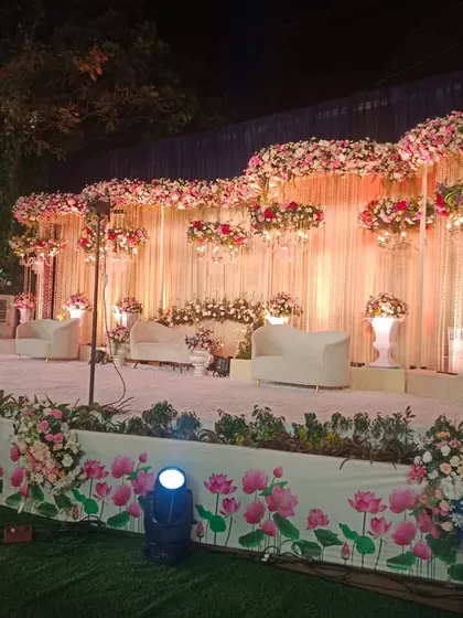 This beautiful floral stage was designed for a night wedding reception at The Acres Club. The arrangement of pink and white flowers with hanging elements creates a dreamy and romantic setting.