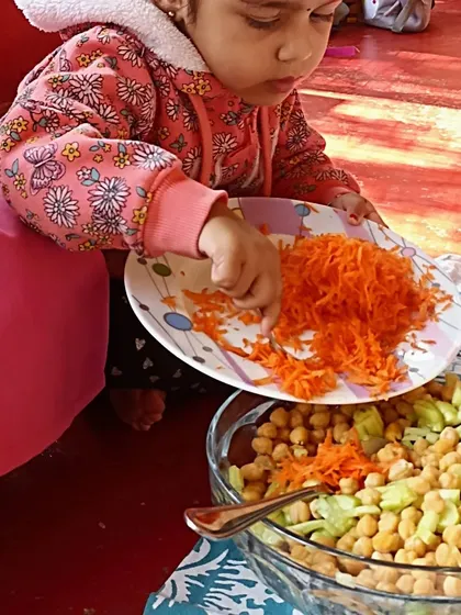 Making a healthy and delicious chickpea salad, where children practiced chopping vegetables and mixing ingredients to create a nutritious meal.