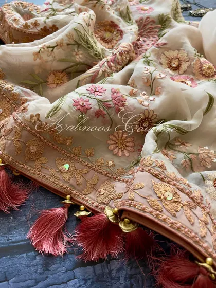 A close-up of the dupatta's corner, showing the tassels and sequin-embellished border.
