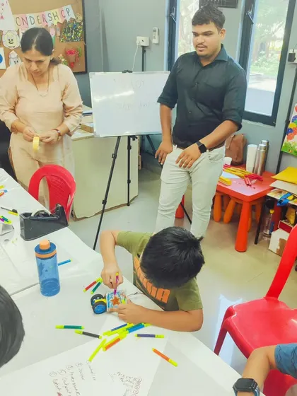 An instructor provides one-on-one guidance, ensuring each child understands the concepts and can successfully build their robotic creation.